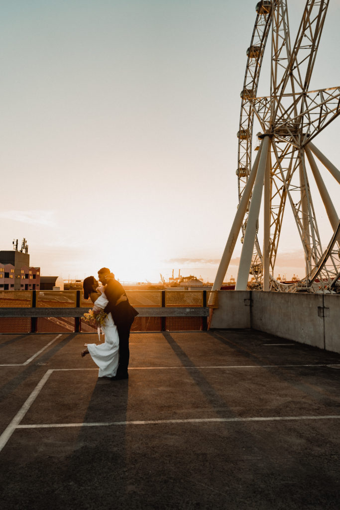 cinematic wedding photo at sunset on rooftop venue in melbourne city